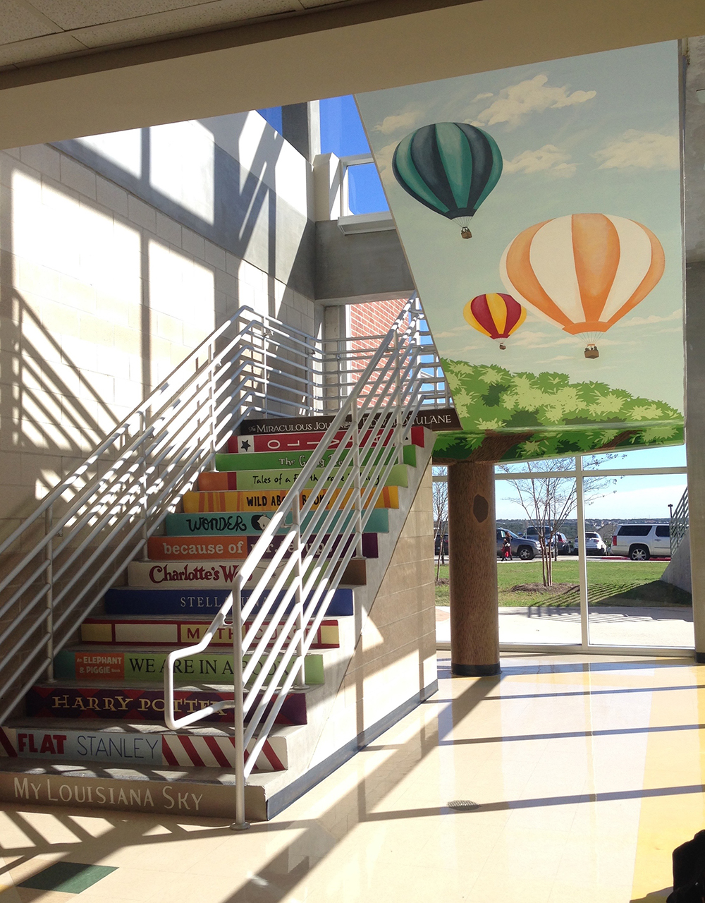 Wide view of the reading nook mural and painted stair.