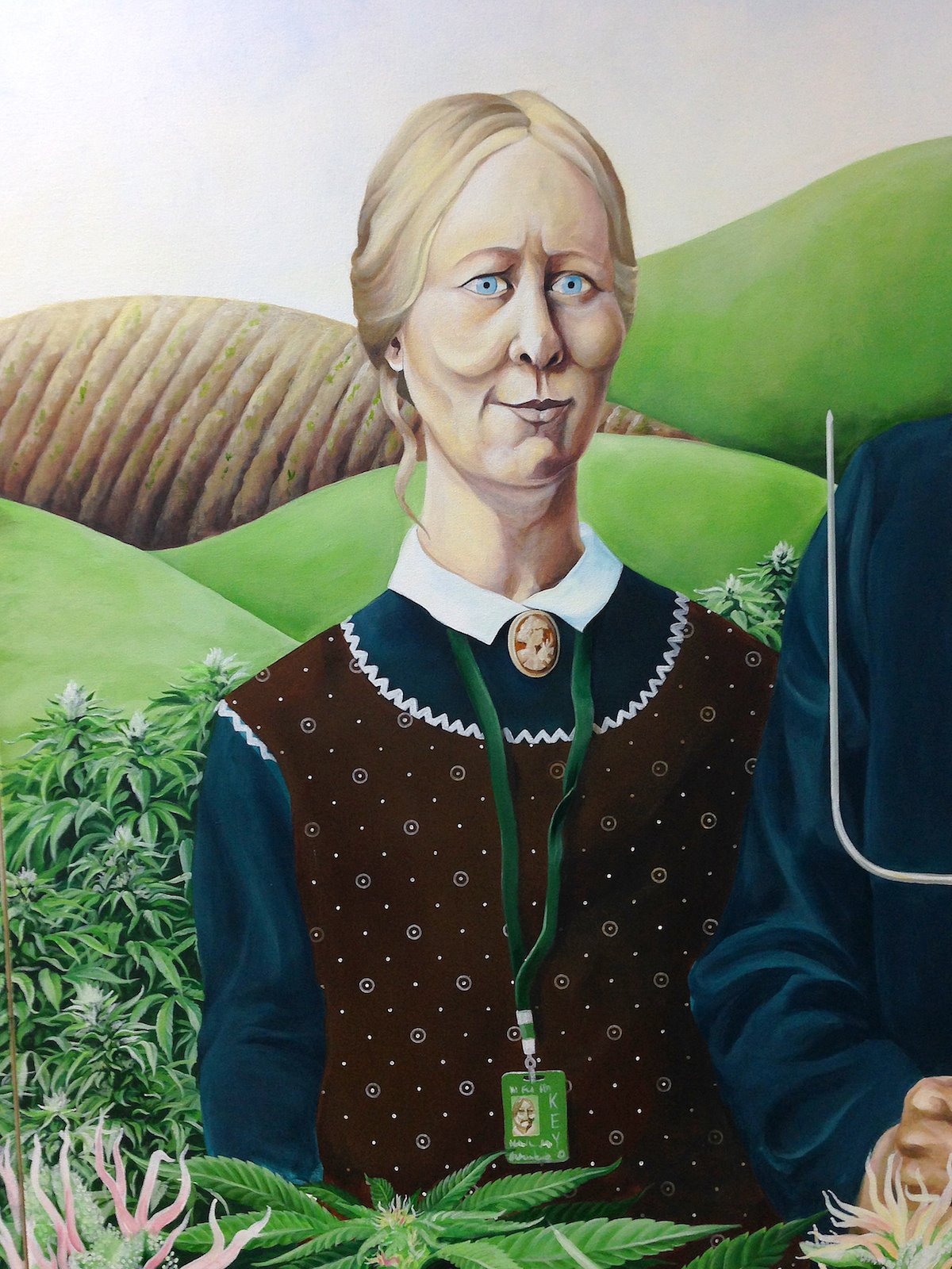 Detail of the painted woman with cameo brooch and badge lanyard.